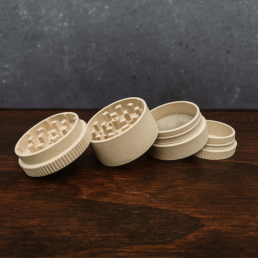 Set of four beige ceramic grinder components on a dark wooden surface with a dark gray background.