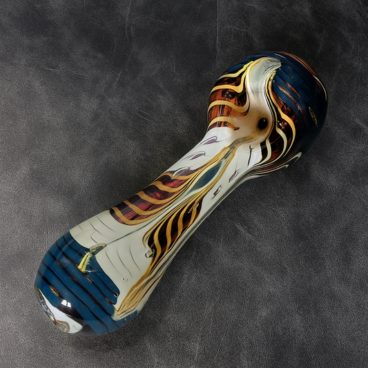 Colorful glass pipe on a dark textured surface