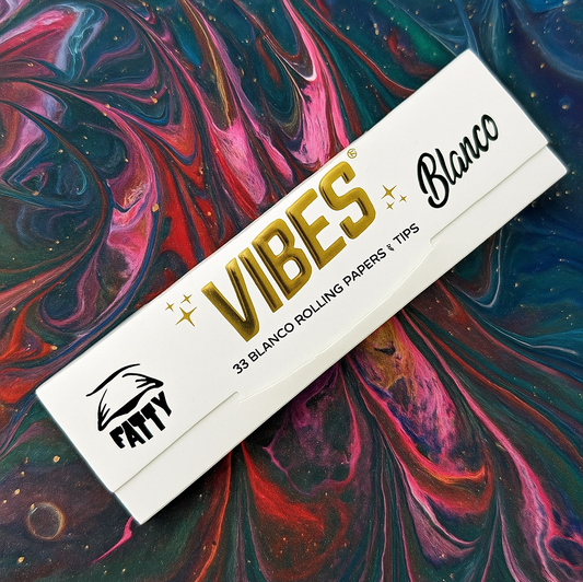 Vibes Blanco rolling paper packaging on a colorful abstract background