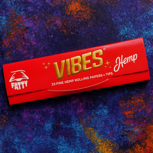 Red package of Fatty Vibes Hemp rolling papers on a colorful textured background